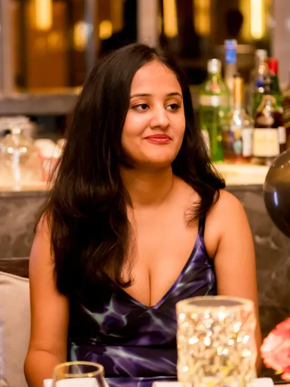 Another candid shot of a guest at the dinner table. We use a telephoto lens to capture these moments from a distance, ensuring people feel comfortable and act naturally.