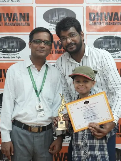 A student receives his award from his proud teachers.