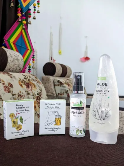 A beautiful flat lay of some of our natural products, including our Honey Lemonade soap, Turmeric Milk soap, Rose Water toner, and Aloe Vera gel.
