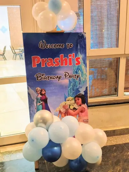 A welcome sign for Prashi's 'Frozen' party, featuring a picture of the birthday girl.