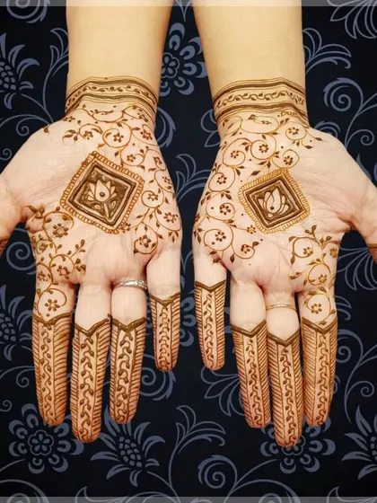 A simple yet elegant design with a central lotus motif in a diamond frame. The delicate vines on the back of the hand add a touch of grace.