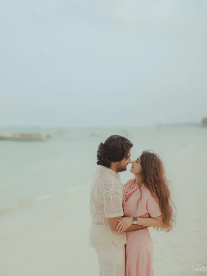 A quiet, intimate portrait of the couple on the beach, with the soft, overcast light creating a gentle and romantic mood.