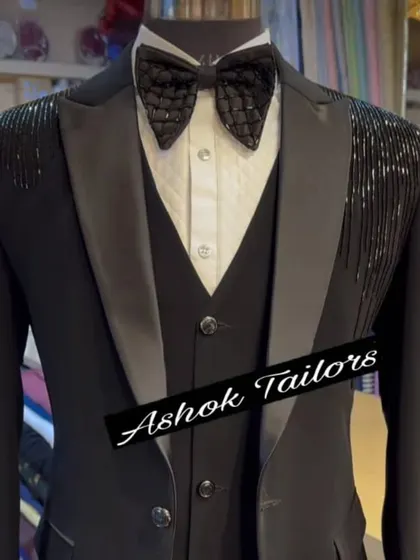 This black tuxedo features sparkling shoulder embellishments. It's a perfect blend of classic tailoring and modern party wear style.