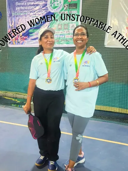 Empowered women, unstoppable athletes. Two of our female players proudly display their medals after a successful pickleball tournament, showcasing their strength and passion.