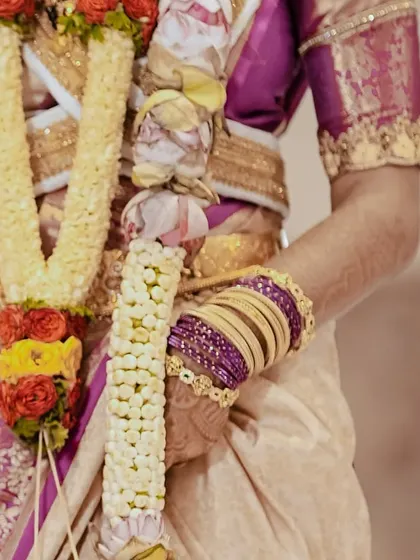 A close-up on the bride's hands, showing the details of her bangles and saree. Every part of the bridal look is important, and I ensure it all comes together perfectly.