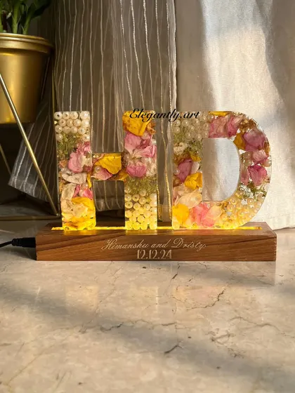 Your memories, your initials, forever illuminated. This 'HD' monogram lamp was created using a couple's wedding garland, preserving their special flowers in a beautiful and functional piece of art.