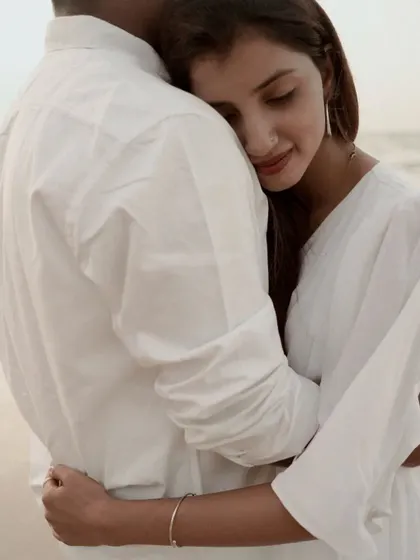 A close-up of her resting her head on his chest. It’s a quiet, intimate moment full of trust and affection.