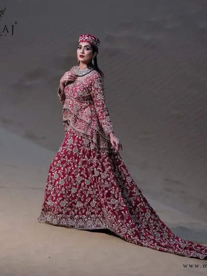 A beautiful rose-gold peplum top with a long tail, handcrafted with overall zardozi work and heavily embroidered borders, perfect for a glorious celebration.