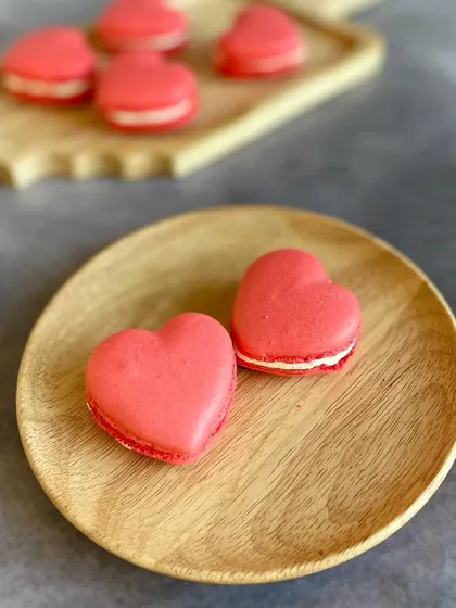 Our Red Velvet Heart Macarons are a brand new addition for Valentine's Day. They have a crisp shell, a chewy center, and a creamy filling, all in a lovely heart shape.