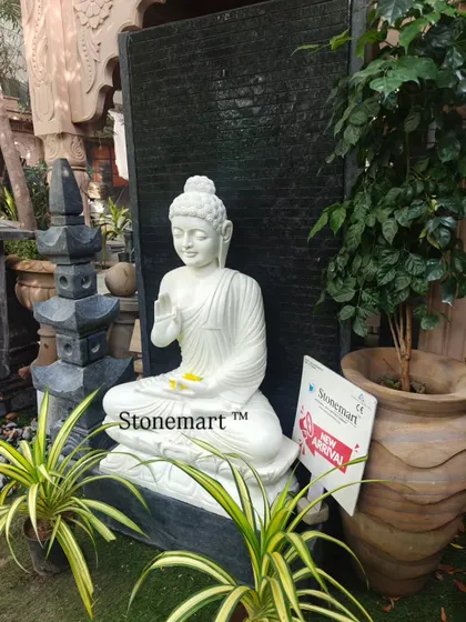 This angle highlights the scale of the 5-foot Buddha fountain, pictured next to a large planter. It's a substantial piece, perfect for resorts, farmhouses, or spacious homes looking for a significant decorative element.