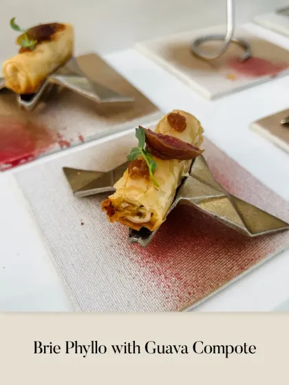 A unique sweet and savory combination: Brie Phyllo with a surprising guava compote, served on an artistic, geometric holder.