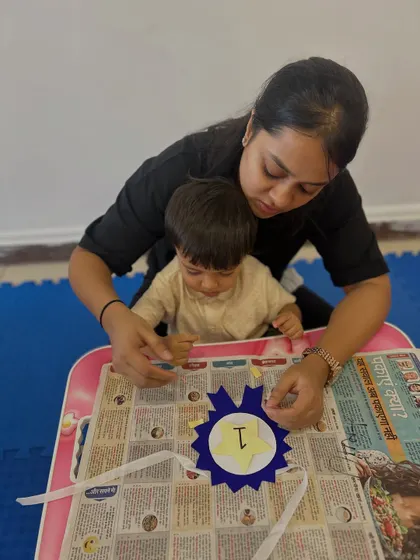 A mother guides her toddler's hand as they work on a craft project together. This gentle guidance helps children develop the pincer grasp and other essential fine motor skills.