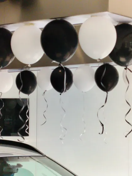 A close-up of the black and white balloon decor used at the NEXA showroom. We pay attention to details like matching ribbons and precise placement to ensure a polished and professional look for our corporate clients.