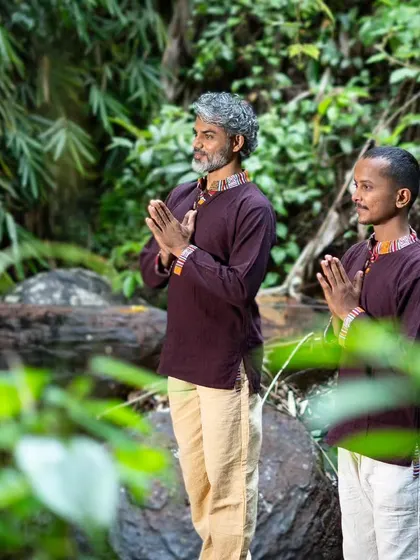 A photo of myself and my co-founder of Nirakula Yoga, standing in nature. We built our shala on the principle of making yoga a holistic and accessible path to well-being for everyone.