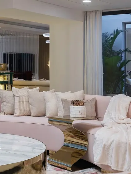 This living room in our Chennai project was inspired by American contemporary design. A soft, curved blush sofa is paired with a statement stone and metal coffee table, creating a space that is poetic, warm, and perfect for gathering.