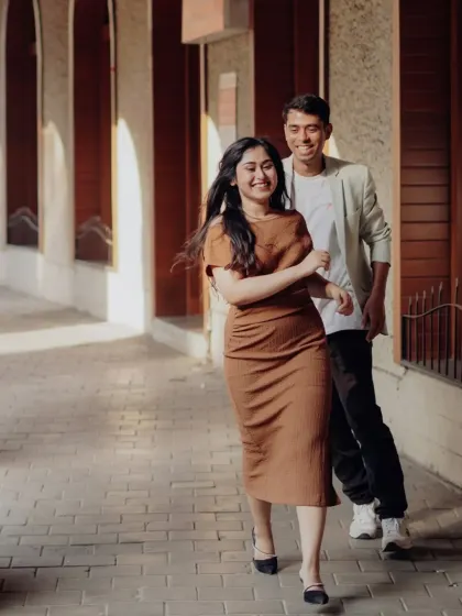 A playful chase through a sunlit city corridor. We encourage laughter and movement to capture your genuine connection and energy as a couple.