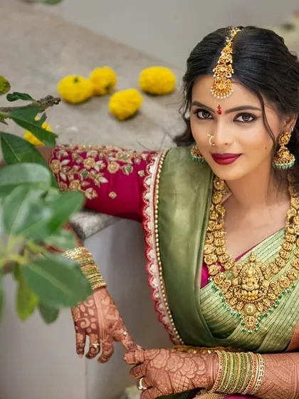 Another beautiful shot of our bride in her green and pink Kanjeevaram ensemble, looking poised and elegant.