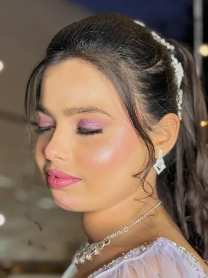 The side profile of this party look, showing the beautiful half-up hairstyle and the glowing highlight.