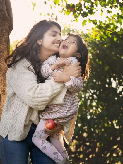 A tickle, a laugh, and a whole lot of love. This candid mother-daughter moment, bathed in beautiful natural light, is what makes outdoor family photography so special.