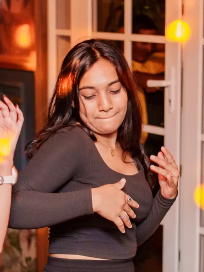 A guest showing off her moves on the dance floor. The energy at VIBE CHECK is all about letting loose and having fun.