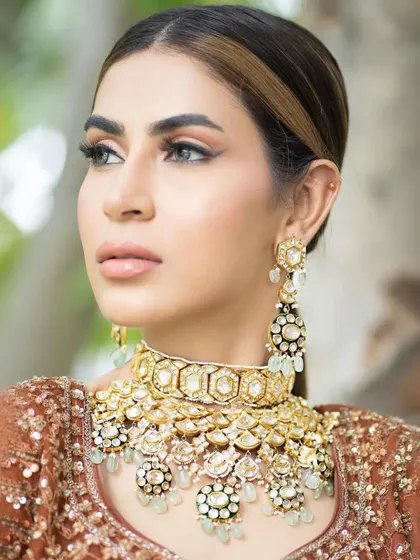 A minimal bridal look perfect for a day wedding. The makeup focuses on a soft base, nude glossy lips, and sleek hairstyling, creating a look that is chic, modern, and effortlessly elegant.