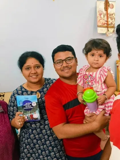 A multi-generational family holding our "GoodZero" plan brochure. We make it easy for everyone to understand the benefits of going solar.