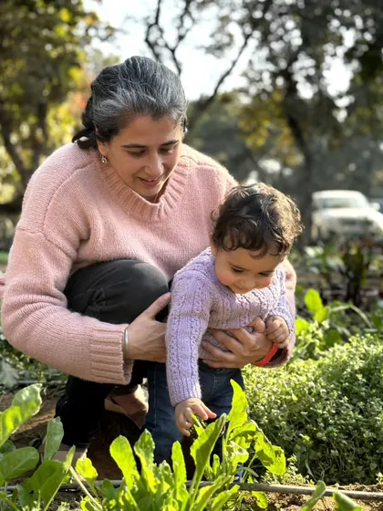 A grandmother and her grandchild exploring the vegetable patch together. Our farm is a place for intergenerational learning and bonding.