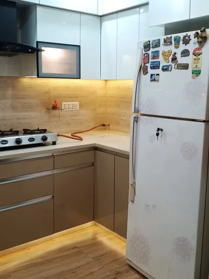 The layout provides ample space for a large refrigerator next to the main counter area.