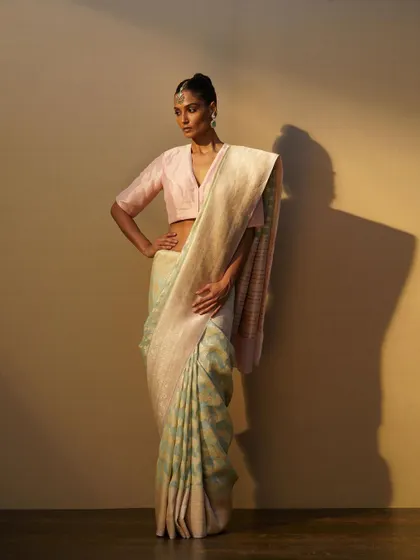 A handwoven saree in pastel shades of mint and pink. I paired it with a simple pink silk blouse to create a soft, summery look.