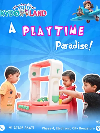 Welcome to a playtime paradise. Three toddlers are completely engaged with a toy kitchen set, demonstrating how our play area is designed for even the youngest explorers to learn and interact.