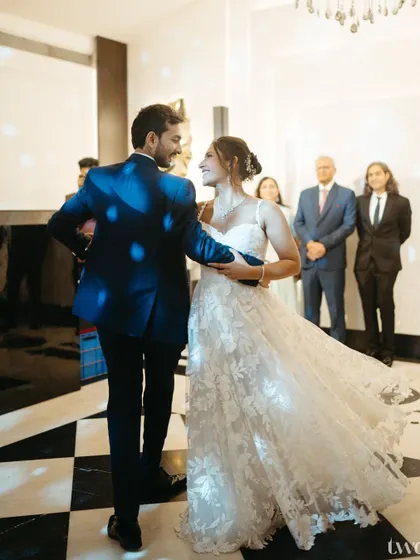 The couple's first dance at their reception. The motion in the bride's dress and their focused gaze on each other makes this a dynamic and romantic shot.