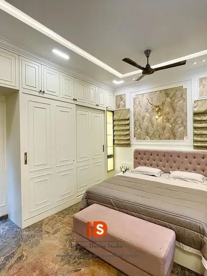 A wider view of the Duco-finished master bedroom, showing the seamless integration of the bed, wardrobes, and a small niche for decorative art.