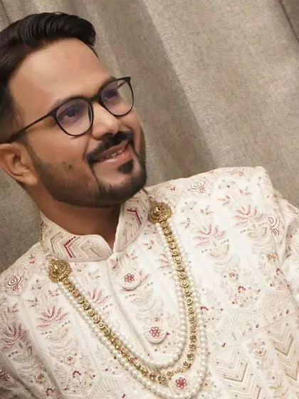 A close-up portrait that highlights the clean makeup and sharp grooming. I focus on enhancing the groom's best features for a confident look.