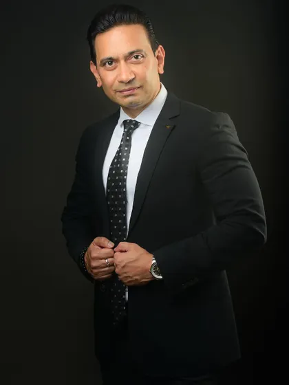 A classic power pose, adjusting the tie. This portrait is perfect for a leader who wants to look sharp, prepared, and in control.