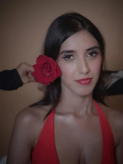 A direct-to-camera shot of this creative makeup look. The glossy red lip and rhinestone eyes are perfect for a beauty editorial.