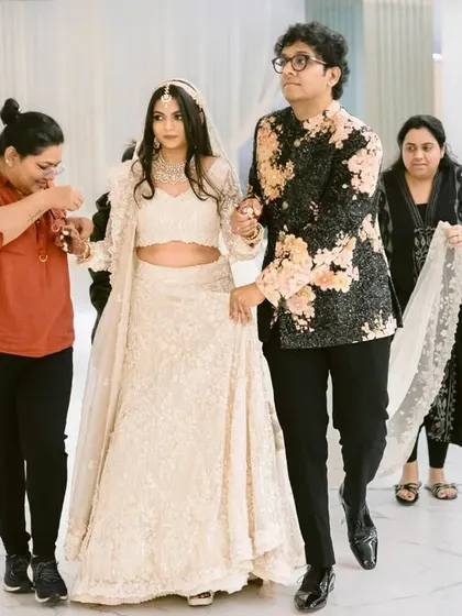 The bride and groom being prepped for their reception, a behind-the-scenes moment showing the team that helps create the magic.