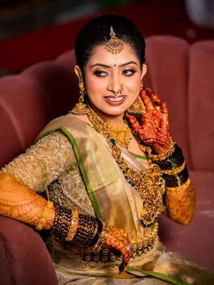 This bride looks absolutely stunning on her pink throne. Her gold saree and custom blouse create a look of pure royalty.