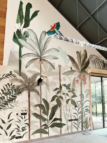 Another full view of the completed rainforest mural, showing how it transforms the double-height wall into a stunning piece of art.