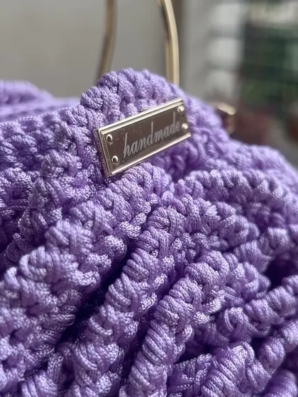 A detailed shot of the lavender Rose Bag, highlighting the metallic "handmade" tag that I add to each piece.
