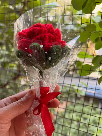 A single red rose, individually wrapped and held in hand. It's a small but meaningful gift that says you care.