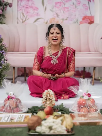 The joy on a bride's face is my greatest reward. Here, Anupa shares a laugh during her engagement ceremony, surrounded by decor that we planned together. It is these happy, personal moments that I strive to create.