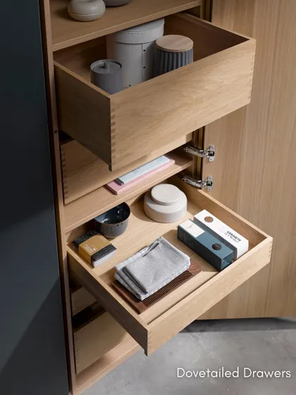 A detail of our dovetailed drawers in a light oak finish. This traditional joinery technique is a hallmark of quality craftsmanship, ensuring durability and strength.