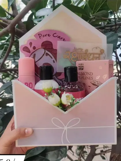 A unique envelope-style hamper for Rakhi. This creative packaging holds a collection of skincare and beauty products, making for a delightful surprise.