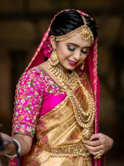 A candid moment from the photoshoot, showing the intricate details of the jewellery, from the layered necklaces to the arm cuffs (vanki).