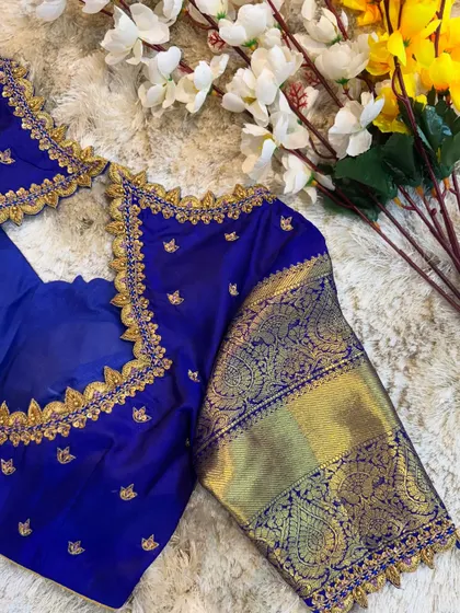 Another view of the royal blue blouse, highlighting the delicate embroidery along the neckline and the rich color of the silk.
