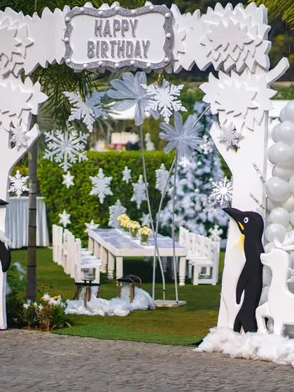 The grand entrance to the winter wonderland party, framed by polar bears, penguins, and snowflake-adorned arches.