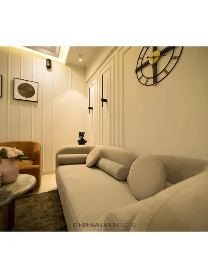 The foyer and living room at our Sushil Advait project. We used a curved sofa and simple, elegant furniture to create a welcoming and uncluttered space that feels both modern and timeless.