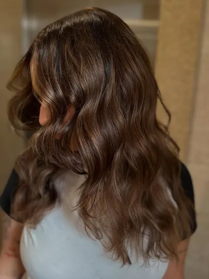 Another angle of the final look. The color is glossy, the waves are soft, and the hair looks incredibly healthy and transformed.