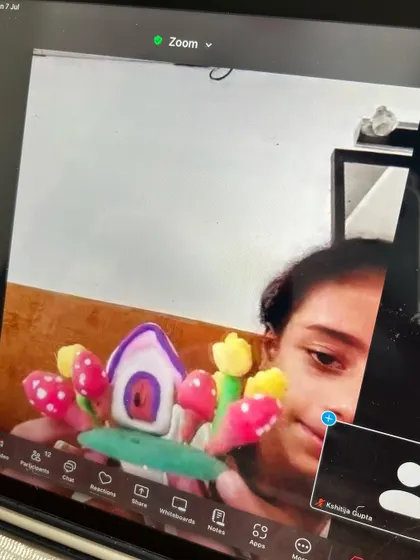 A student showing her finished miniature clay house during our online Zoom class. The details are just adorable.