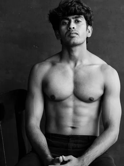 A classic male physique portrait in black and white. The lighting is designed to define and sculpt the muscles, creating a powerful and timeless image for an actor or fitness model's portfolio.